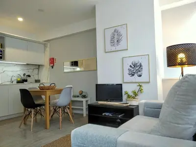 a living room with a couch and a table at Downtown Porto Spot in Porto
