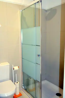 a glass shower in a bathroom with a toilet at Downtown Porto Spot in Porto