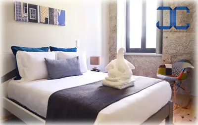 a bedroom with a bed with a stuffed animal on it at Click! Apartment by JC in Porto