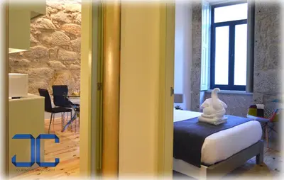 a bedroom with a bed and a table with chairs at Click! Apartment by JC in Porto