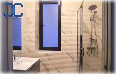 a bathroom with a sink and a shower with a window at Click! Apartment by JC in Porto