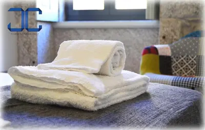 a stack of towels sitting on top of a table at Click! Apartment by JC in Porto