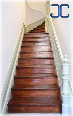 a staircase with wooden floors and white railings at Click! Apartment by JC in Porto