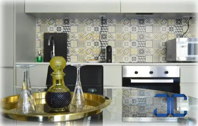 a kitchen with a glass table with two wine glasses at Click! Apartment by JC in Porto