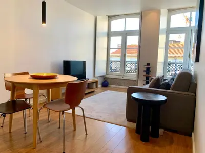 a living room with a table and a couch at RIBEIRA OPORTO APARTMENT (NEW) in Porto