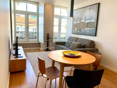 a living room with a table and a couch at RIBEIRA OPORTO APARTMENT (NEW) in Porto
