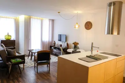 a living room with a kitchen and a living room with a couch at Vintage Porto in Porto