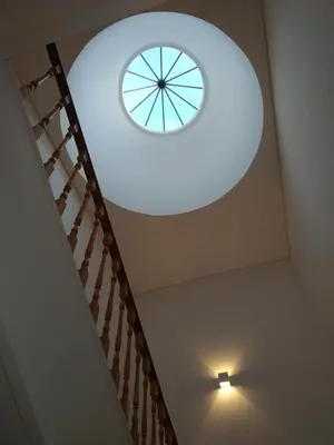 a ceiling with a clock on top of a staircase at ML Apartments Republic in Porto