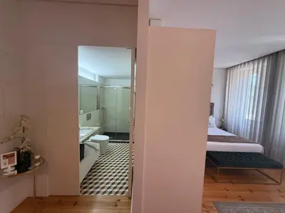 a room with a bathroom with a bed and a mirror at ML Apartments Republic in Porto