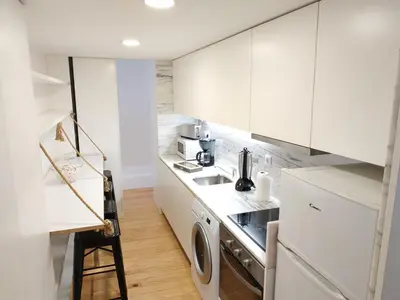 a white kitchen with a sink and a dishwasher at ML Apartments River in Porto