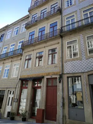 an apartment building with a red door and windows at ML Apartments River in Porto