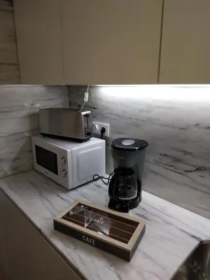a kitchen counter with a microwave and a coffee maker at ML Apartments River in Porto