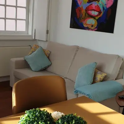a living room with a couch and a table at Lux Ribeira - ALL INCLUDED in Porto