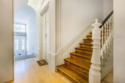 a bedroom with a bed and a table and a window at Santa Catarina Downtown Flat in Porto