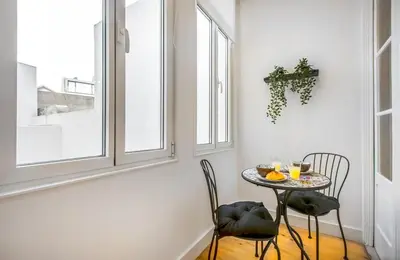 a living room with a table and a couch at Santa Catarina Downtown Flat in Porto