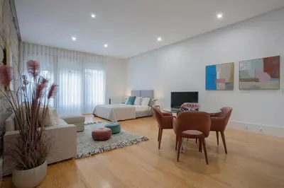 a living room with a table and a couch at Liiiving In Porto | Downtown Luxury Apartments in Porto