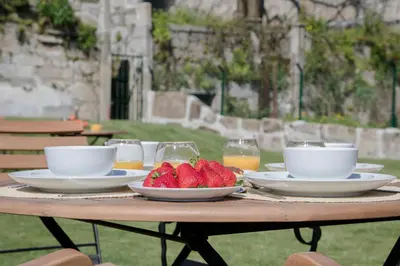 a table with plates of food and strawberries on it at Liiiving In Porto | Downtown Luxury Apartments in Porto