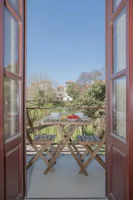 a table and chairs sitting on a balcony with a view of a balcony at Liiiving In Porto | Downtown Luxury Apartments in Porto