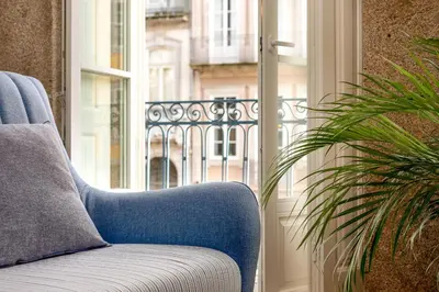 a blue chair sitting in front of a window at RS Porto Historic Center in Porto