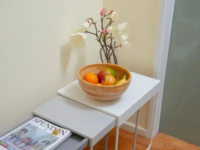 a bowl of fruit on a white table with a magazine at Oporto Guest Alegria Flat Downtown in Porto