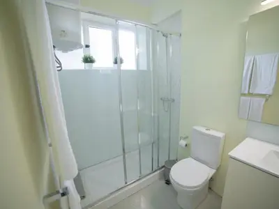 a white bathroom with a shower and a toilet at Oporto Guest Alegria Flat Downtown in Porto