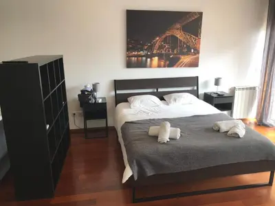 a bedroom with a bed with two towels on it at Metro Heroismo Residence in Porto