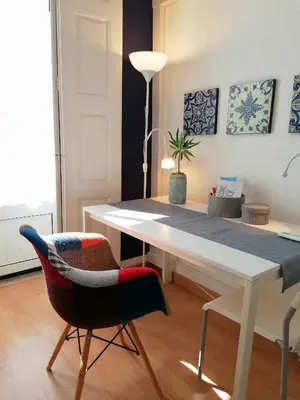 a room with a white table and a chair at Downtown Porto Spot - 2 bedrooms in Porto