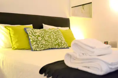 a bedroom with a bed with towels on it at Downtown Porto Spot - 2 bedrooms in Porto