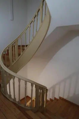 a spiral staircase in a home with white walls and wooden floors at Apartamentos sobre o Douro in Porto