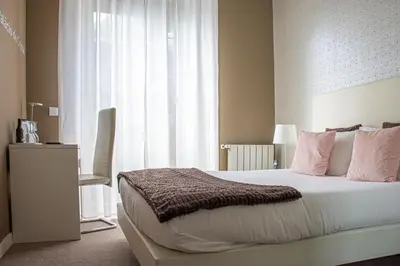 a bedroom with a bed with pink pillows and a window at O'Porto Seven - Guest House in Porto