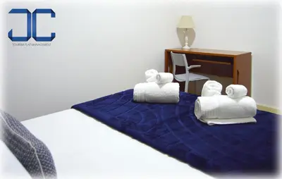 a group of rolled towels on a bed at Market Place (with 2 Bedrooms) by JC in Porto