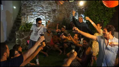 a group of people raising their hands in the air at Hostel Gaia Porto in Vila Nova de Gaia
