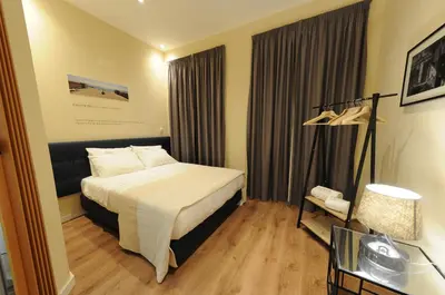 a hotel room with a bed and a glass table at Naya-Downtown Guesthouse in Porto