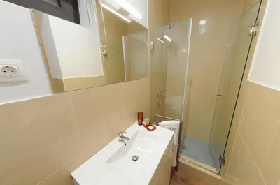 a bathroom with a sink and a shower at Naya-Downtown Guesthouse in Porto