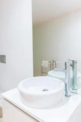 a bathroom with a white sink on a counter at Aposentus -Romantic Mezzanine Apartment With a Balcony in Porto