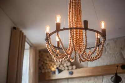a chandelier with beads hanging from a ceiling at Little Capeli in Porto