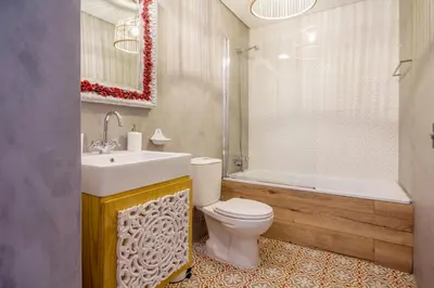 a bathroom with a toilet and a sink and a tub at Little Capeli in Porto