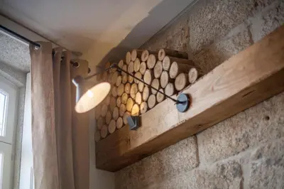 a wall with a bunch of wood on it at Little Capeli in Porto