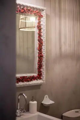a bathroom with a mirror and a toilet and a sink at Little Capeli in Porto