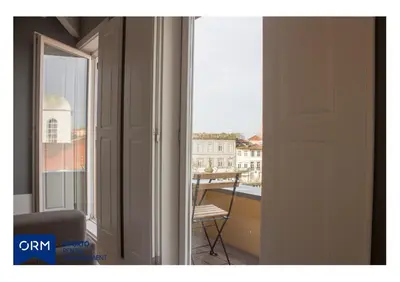 a room with a window with a view of a building at ORM Praça Apartment in Porto