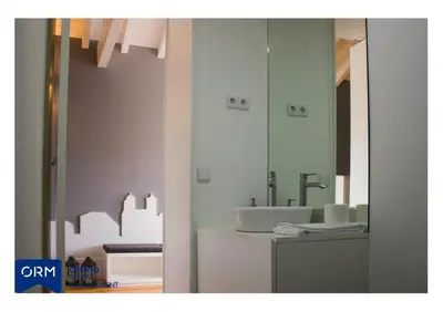 a bathroom with a sink and a mirror at ORM Praça Apartment in Porto