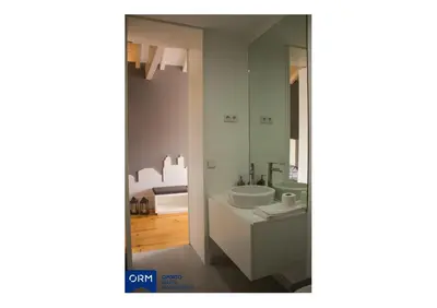 a white bathroom with a sink and a mirror at ORM Praça Apartment in Porto