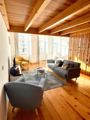 a living room with two couches and a table at 1118 Lofts in Porto