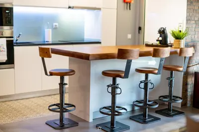 a kitchen with a wooden counter with bar stools at Porto Cathedral in Porto