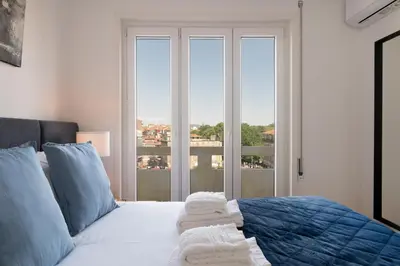a bedroom with a bed with towels on it at Poveiros Terrace - 3BR Downtown apartment with AC in Porto