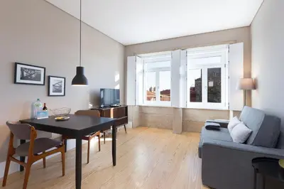 a living room with a table and a couch at Porto and Clérigos Views by Porto City Hosts in Porto