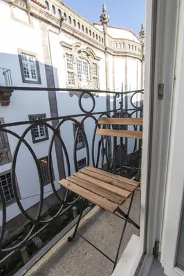a wooden bench sitting on top of a balcony at Porto and Clérigos Views by Porto City Hosts in Porto