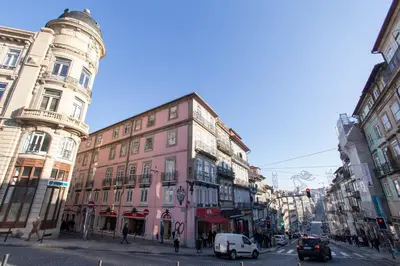 a pink building on a city street with cars at Porto and Clérigos Views by Porto City Hosts in Porto