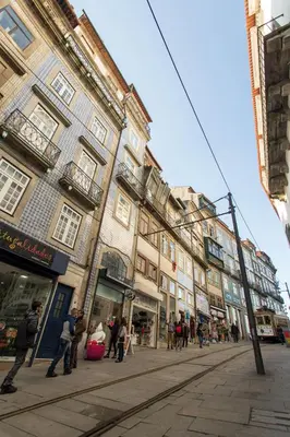 a group of people walking down a street with buildings at Porto and Clérigos Views by Porto City Hosts in Porto