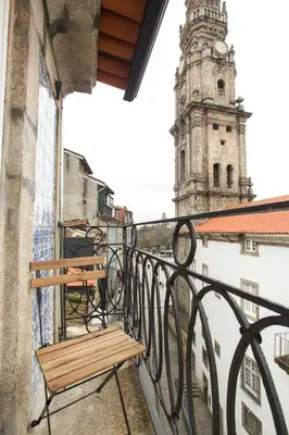 a bench on a balcony with a clock tower at Porto and Clérigos Views by Porto City Hosts in Porto